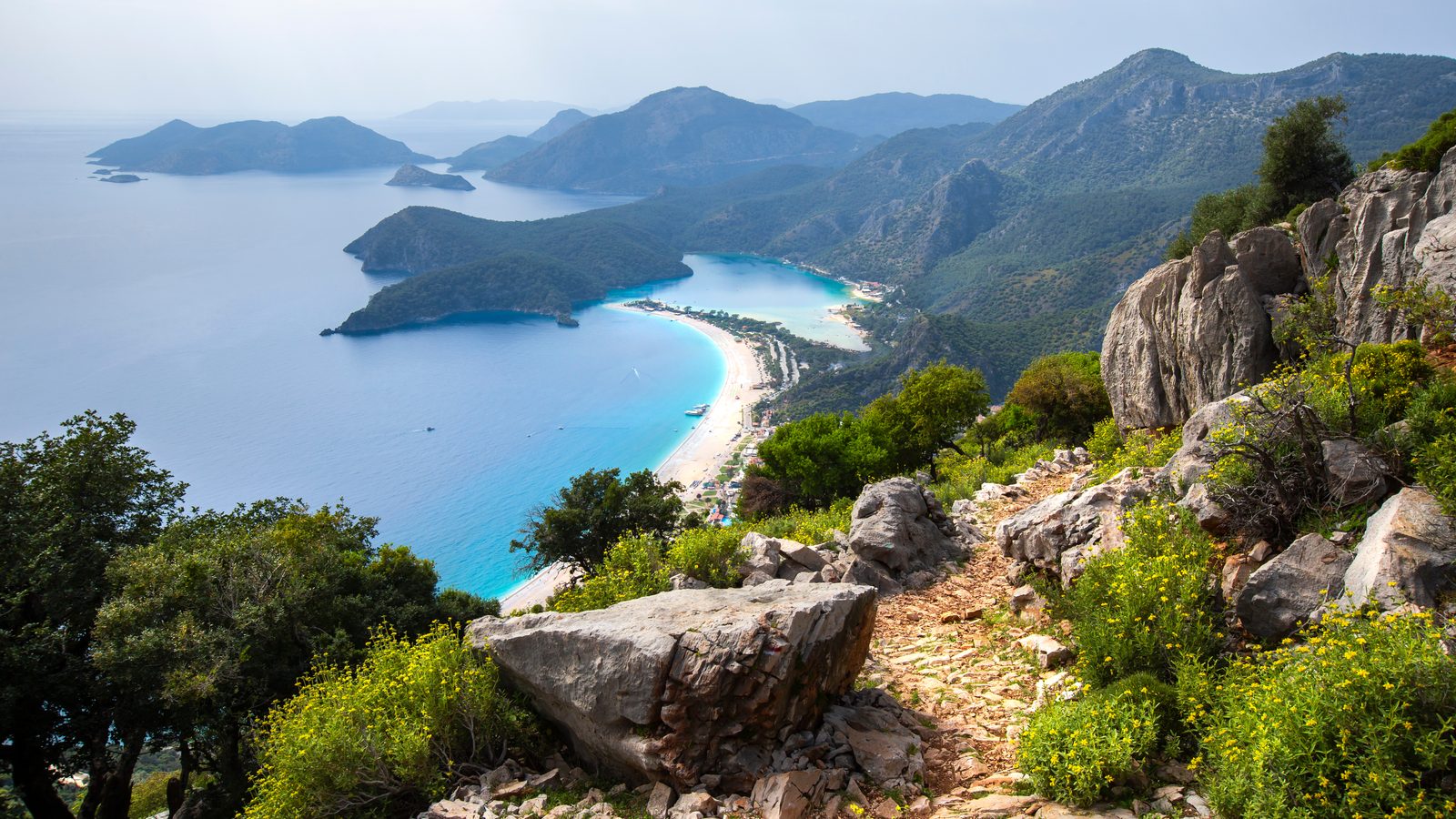 The Ölüdeniz lagoon and beach seen from a rocky path high on the coastal trail above the resort